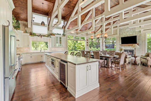 kitchen featuring wooden ceiling, a center island, dark wood-type flooring, and plenty of natural light