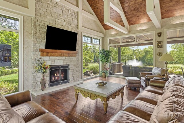 living room with a fireplace, high vaulted ceiling, and a wealth of natural light