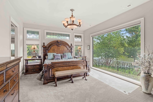 bedroom with a notable chandelier and light carpet