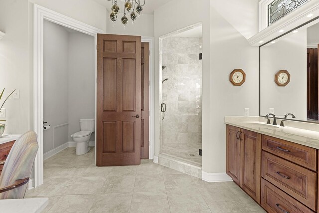 bathroom featuring a notable chandelier, vanity, tile patterned flooring, an enclosed shower, and toilet