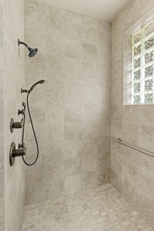 bathroom with tiled shower