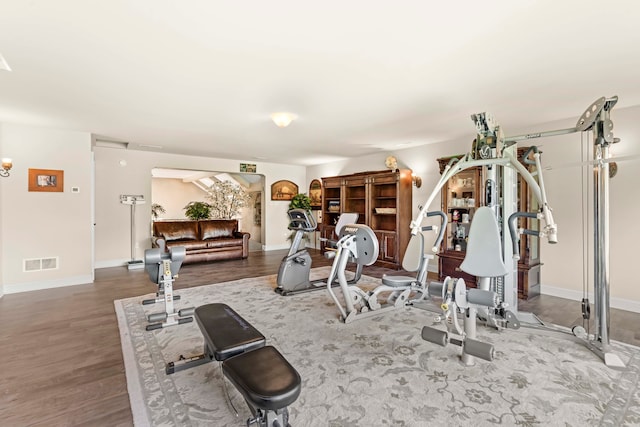 exercise room featuring dark hardwood / wood-style floors