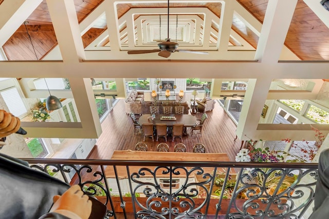 interior space with high vaulted ceiling, a healthy amount of sunlight, and hardwood / wood-style flooring