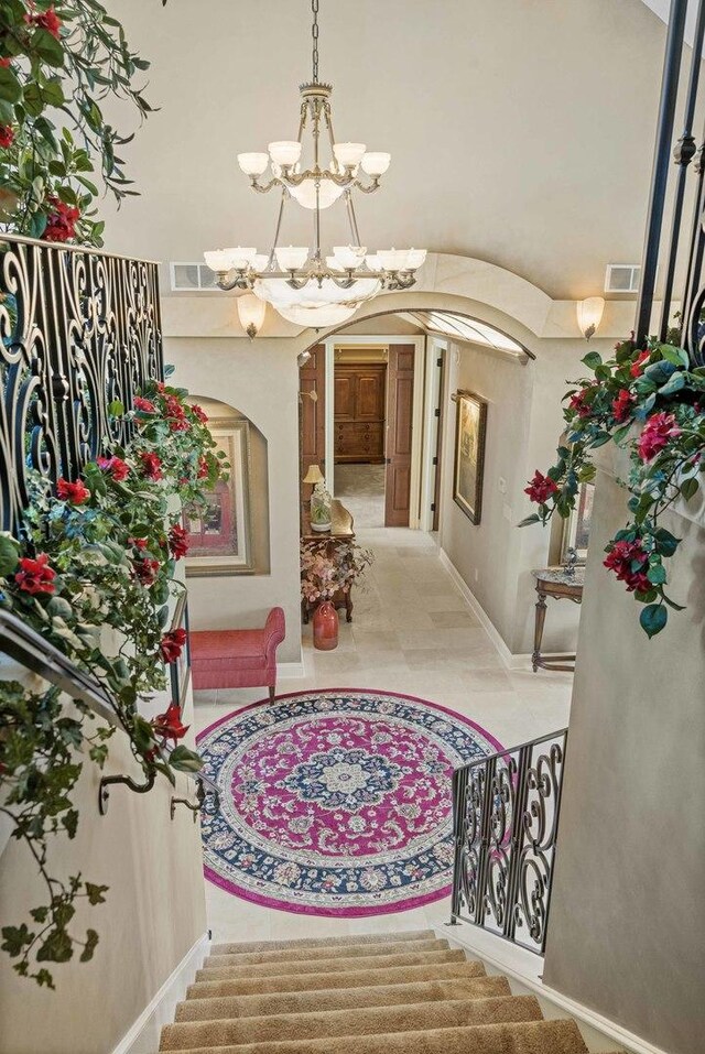 tiled entryway featuring an inviting chandelier