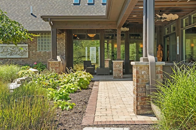 view of exterior entry with a patio