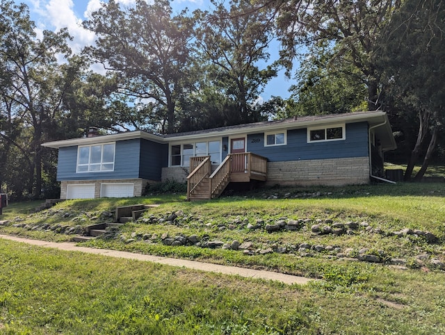 view of front of property with a front lawn and a garage