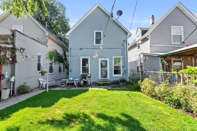 rear view of property with a patio area, a yard, central AC, and ceiling fan