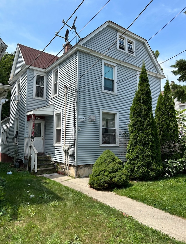 rear view of house with a lawn