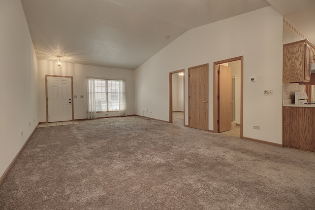 interior space with light colored carpet and lofted ceiling