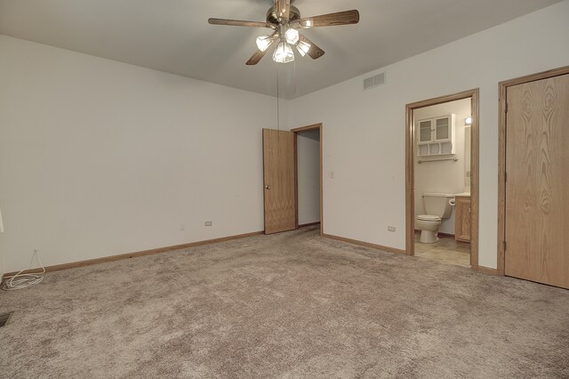 unfurnished bedroom with ceiling fan, light carpet, and ensuite bathroom