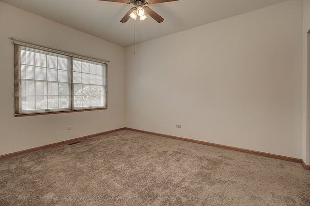 carpeted spare room with ceiling fan