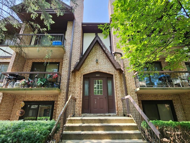 2809 Glenwood Lansing Rd Unit 309, Lynwood, IL 60411 - doorway to property with brick siding and a balcony