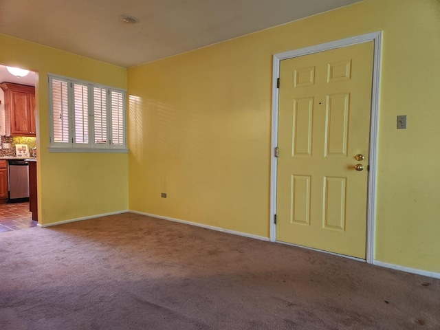 unfurnished room with light colored carpet