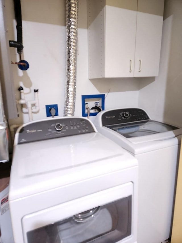 clothes washing area with washing machine and clothes dryer