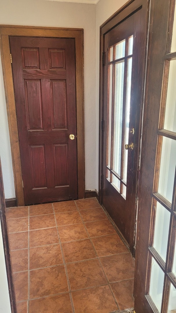 doorway with tile patterned floors