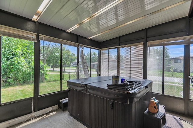 sunroom with plenty of natural light and a jacuzzi