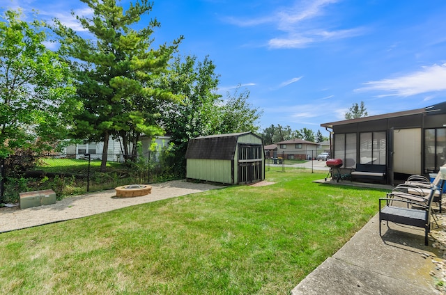 view of yard featuring an outdoor fire pit and a sunroom