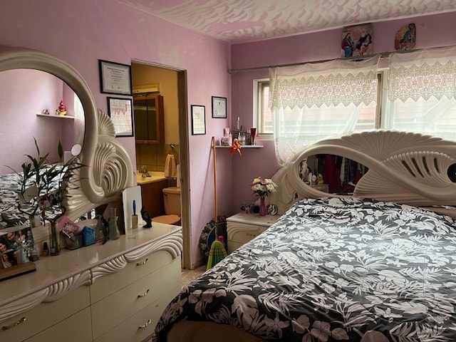 carpeted bedroom featuring ensuite bathroom