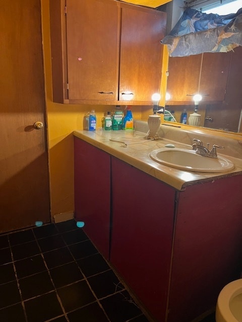 interior space with sink and dark tile patterned floors