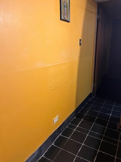 hallway featuring tile patterned flooring