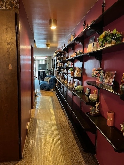 hallway featuring light carpet