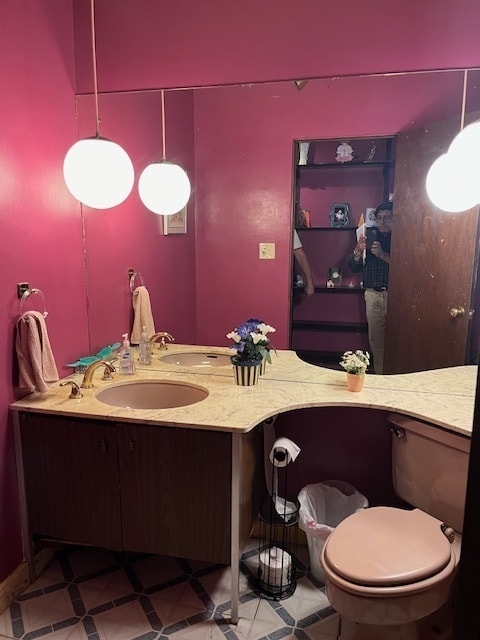 bathroom featuring toilet, tile patterned floors, and vanity