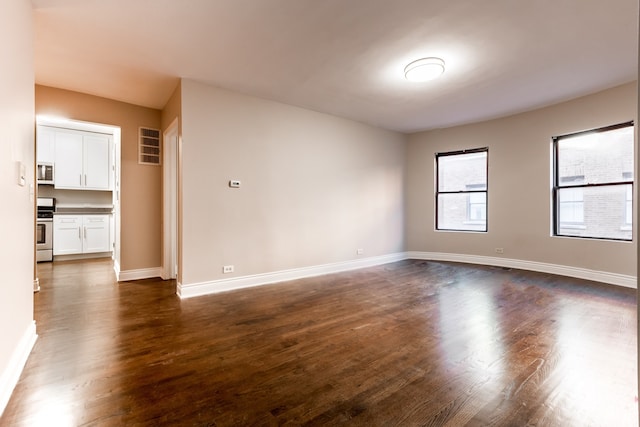 unfurnished room with hardwood / wood-style flooring