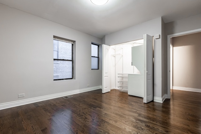 unfurnished bedroom featuring dark wood-type flooring