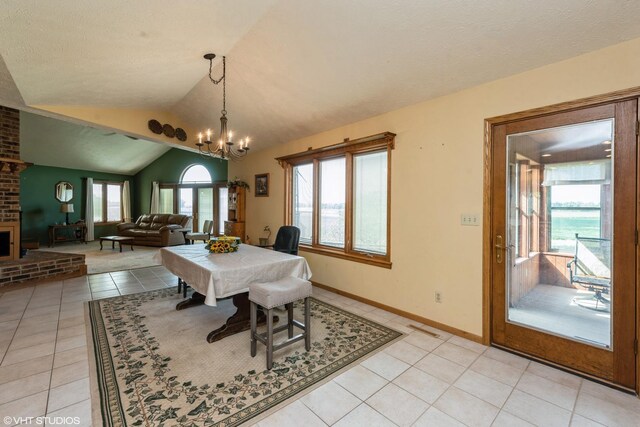 tiled dining space with vaulted ceiling, an inviting chandelier, and brick wall