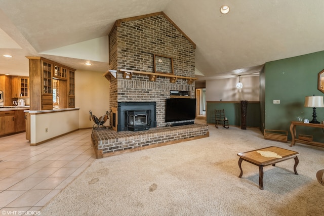 living room featuring light colored carpet, high vaulted ceiling, a brick fireplace, and brick wall