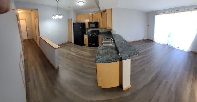 kitchen with black appliances, wood-type flooring, sink, kitchen peninsula, and an inviting chandelier