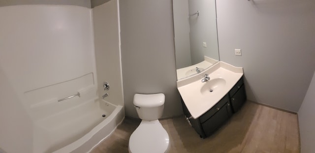 full bathroom featuring hardwood / wood-style flooring, tub / shower combination, toilet, and vanity