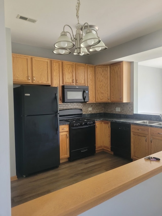 kitchen featuring an inviting chandelier, tasteful backsplash, sink, black appliances, and dark hardwood / wood-style flooring