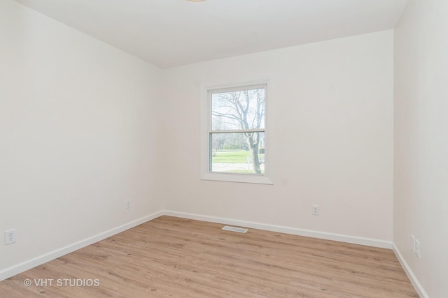 spare room with light hardwood / wood-style flooring