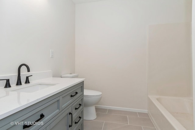 bathroom with a bathtub, tile patterned flooring, vanity, and toilet