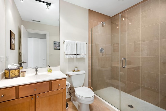 758 N Larrabee St Unit 811, Chicago, IL 60654 - full bath with vanity, toilet, tile patterned floors, a shower stall, and visible vents