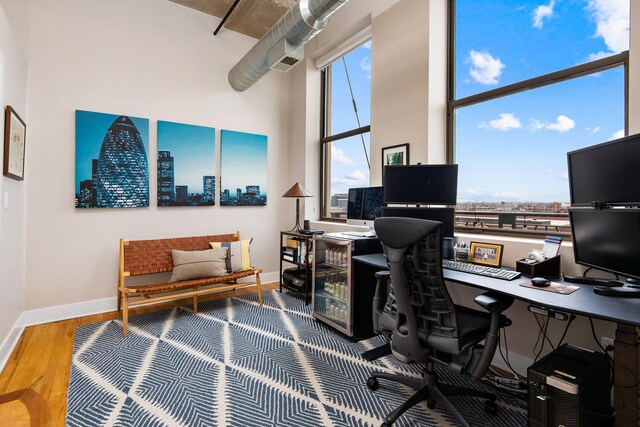 758 N Larrabee St Unit 811, Chicago, IL 60654 - home office featuring baseboards, a high ceiling, and wood finished floors