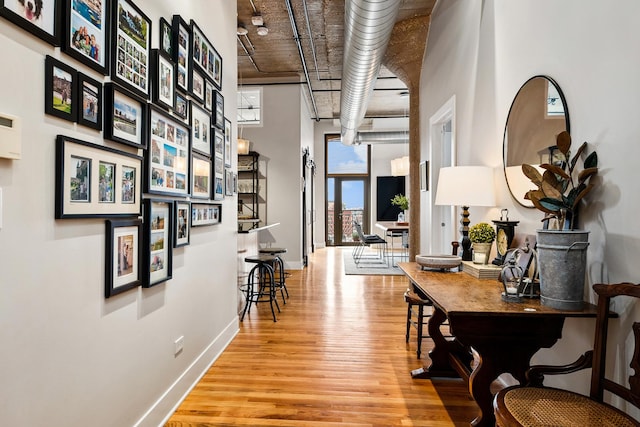 758 N Larrabee St Unit 811, Chicago, IL 60654 - hall with baseboards, a high ceiling, and wood finished floors