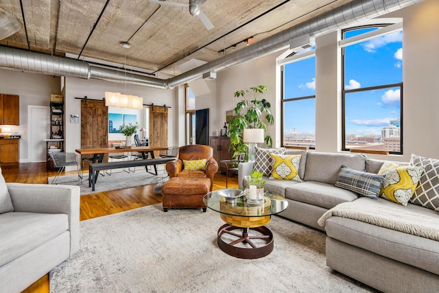 758 N Larrabee St Unit 811, Chicago, IL 60654 - living room with a barn door, wood finished floors, and a wealth of natural light
