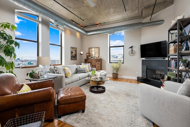 758 N Larrabee St Unit 811, Chicago, IL 60654 - living room featuring baseboards, wood finished floors, and a tile fireplace