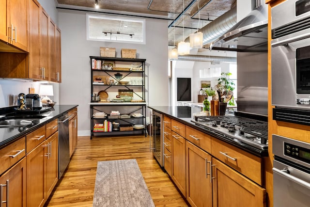 758 N Larrabee St Unit 811, Chicago, IL 60654 - kitchen with brown cabinets, beverage cooler, rail lighting, stainless steel appliances, and light wood-type flooring