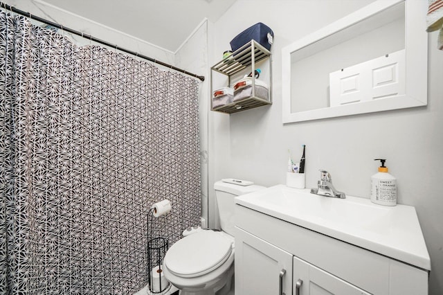 bathroom with curtained shower, vanity, and toilet