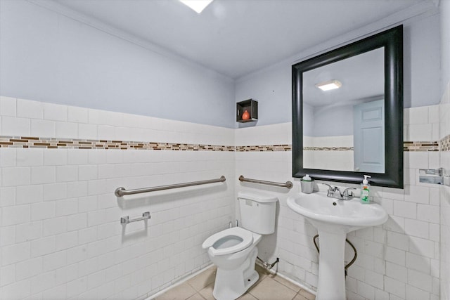 bathroom featuring tile patterned floors, ornamental molding, tile walls, and toilet