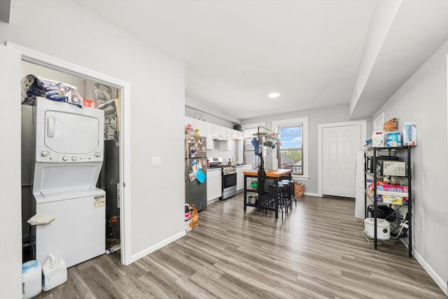 interior space featuring hardwood / wood-style floors and stacked washer and clothes dryer