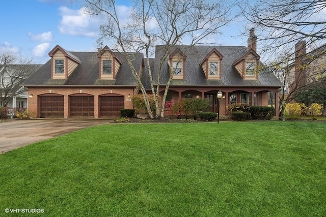 cape cod house with a front yard and a garage