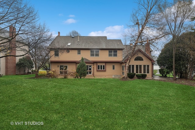 rear view of house with a yard