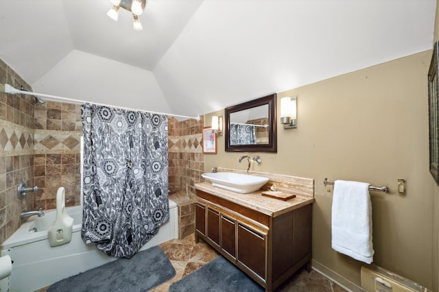 bathroom with vanity, shower / tub combo with curtain, tile walls, and vaulted ceiling