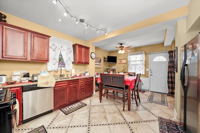 kitchen featuring sink, stainless steel appliances, light tile patterned floors, and ceiling fan