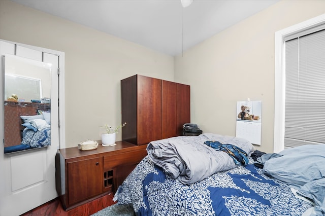 bedroom with dark hardwood / wood-style flooring