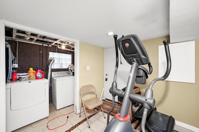 workout room with independent washer and dryer and light tile patterned flooring